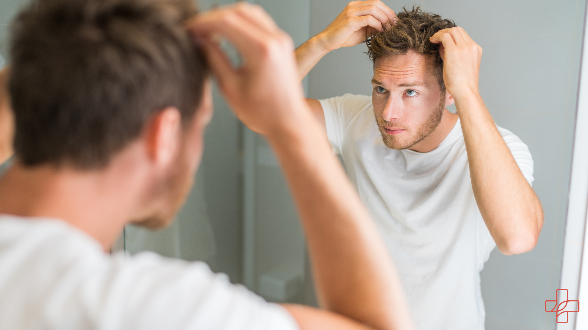 Mann richtet seine Haare im Spielgel Hypogen Care
